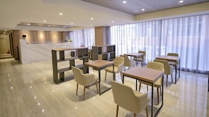 A modern hotel lobby with a reception desk, seating area, and large windows. - Ximen Hotel (Taipei)