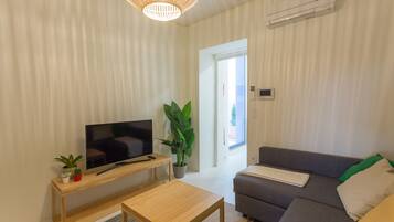 Apartment, 1 Bedroom | Living room | Flat-screen TV