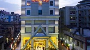 A multi-story hotel with a central entrance and a neon sign above. - Gargee Grand Patna (Patna)