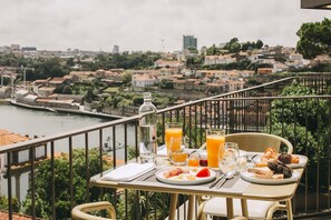 Enjoy meals on the balcony with a view of the city and its river.