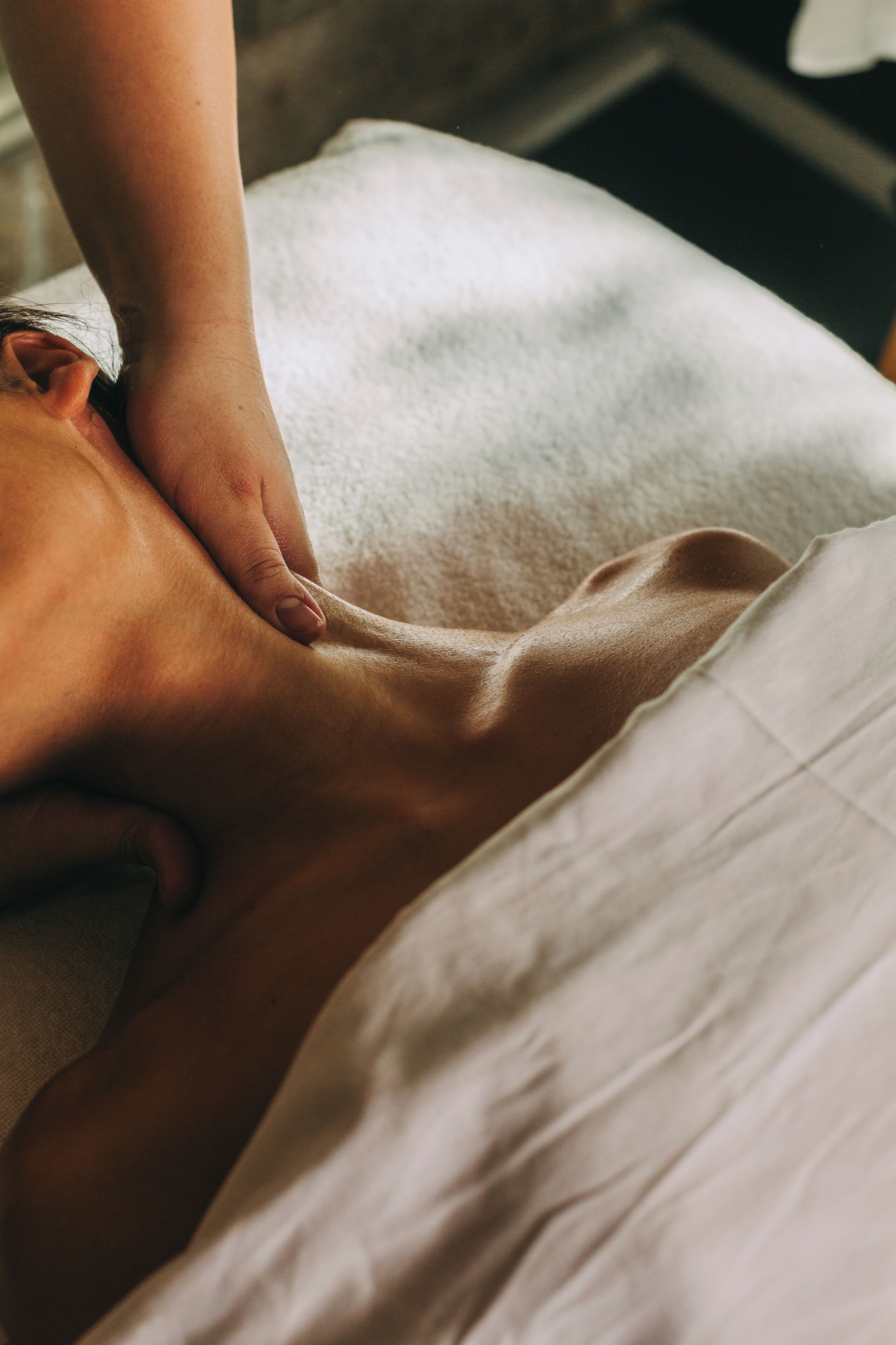 A close-up of a massage being performed on a person's back.
