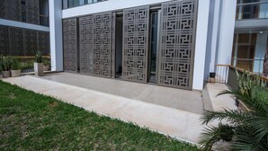 A modern building with large windows and decorative metal screens. - Marina Rabat Suites & Apartments (Salé)