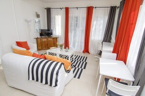 Apartment, 1 Queen Bed with Sofa bed, Kitchenette | Living room | 32-inch flat-screen TV with cable channels, TV