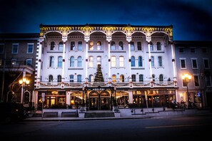 A historic hotel with a grand facade, multiple stories, and a central entrance with a Christmas tree. - The Adelphi Hotel (Saratoga Springs)