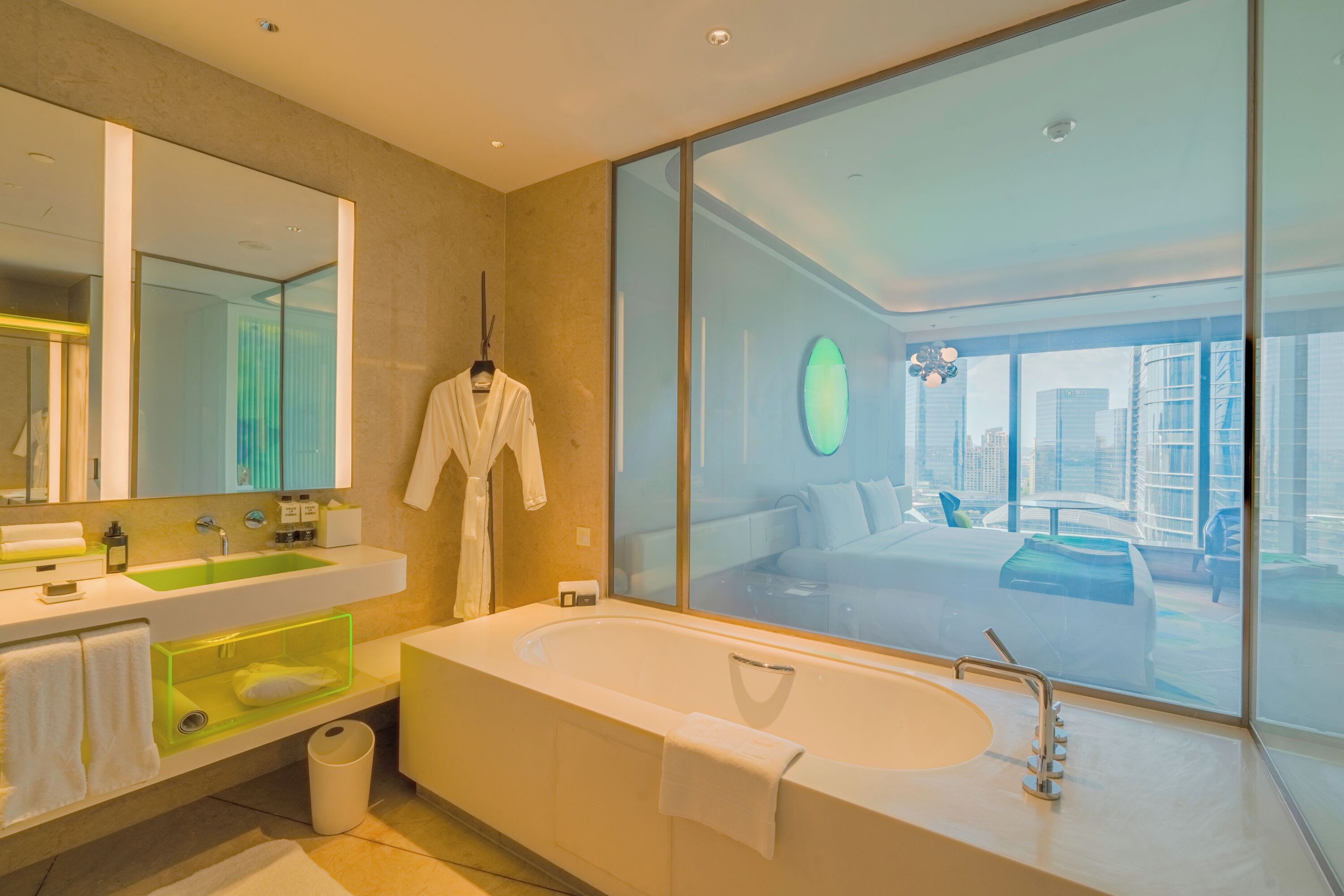 A modern bathroom with a large bathtub, a dual sink vanity, and a large mirror.