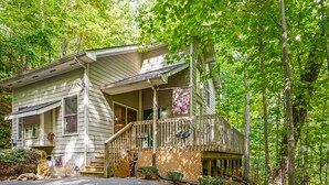 A two-story house with a porch, a staircase, and a wooden deck. - 1 Bedroom, Sleeps 4, Minutes To Downtown Gatlinburg, Pool Table (Gatlinburg)