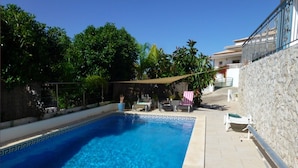 A rectangular swimming pool with clear blue water, surrounded by a stone wall and a tiled deck. - LUXURY 4 BED VILLA WITH PRIVATE POOL NEAR BEACH AND GOLF ☀️ (Castro Marim)