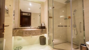 A modern bathroom with a glass-enclosed shower, a marble countertop, and a large mirror. - Changzhou Joyland Gloria Grand Hotels (Changzhou)