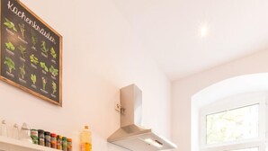 A modern kitchen with white cabinetry, a wooden countertop, a built-in oven, a microwave, and a window with a view of the outdoors. - FRITZ 3 bedrooms, 2 bathrooms, 2 kitchens, 115 sqm, free wifi, box spring beds (Berlin)