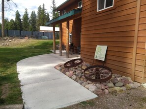 Enjoy outdoor dining or relaxation on the covered porch with a table and chairs.