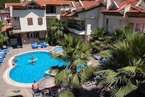 Piscine extérieure, parasols de plage, chaises longues