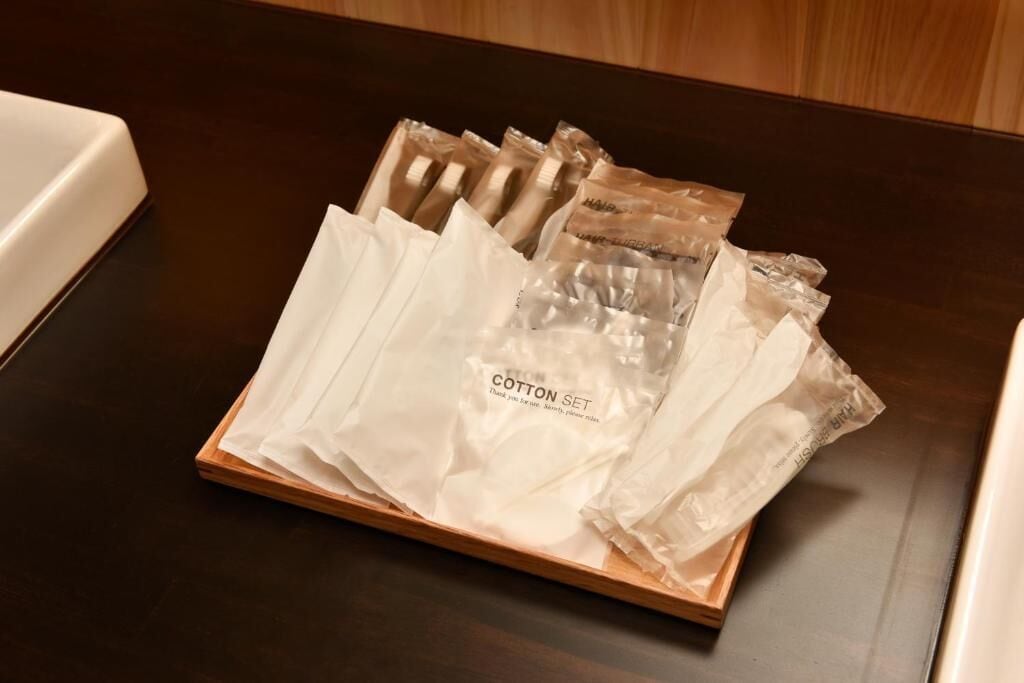 A tray with several packages labeled "Cotton Set" on a wooden table.