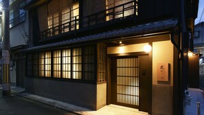A traditional Japanese building with a wooden entrance, large windows, and a signboard. - KURAYA Nanseicho (Kyoto)