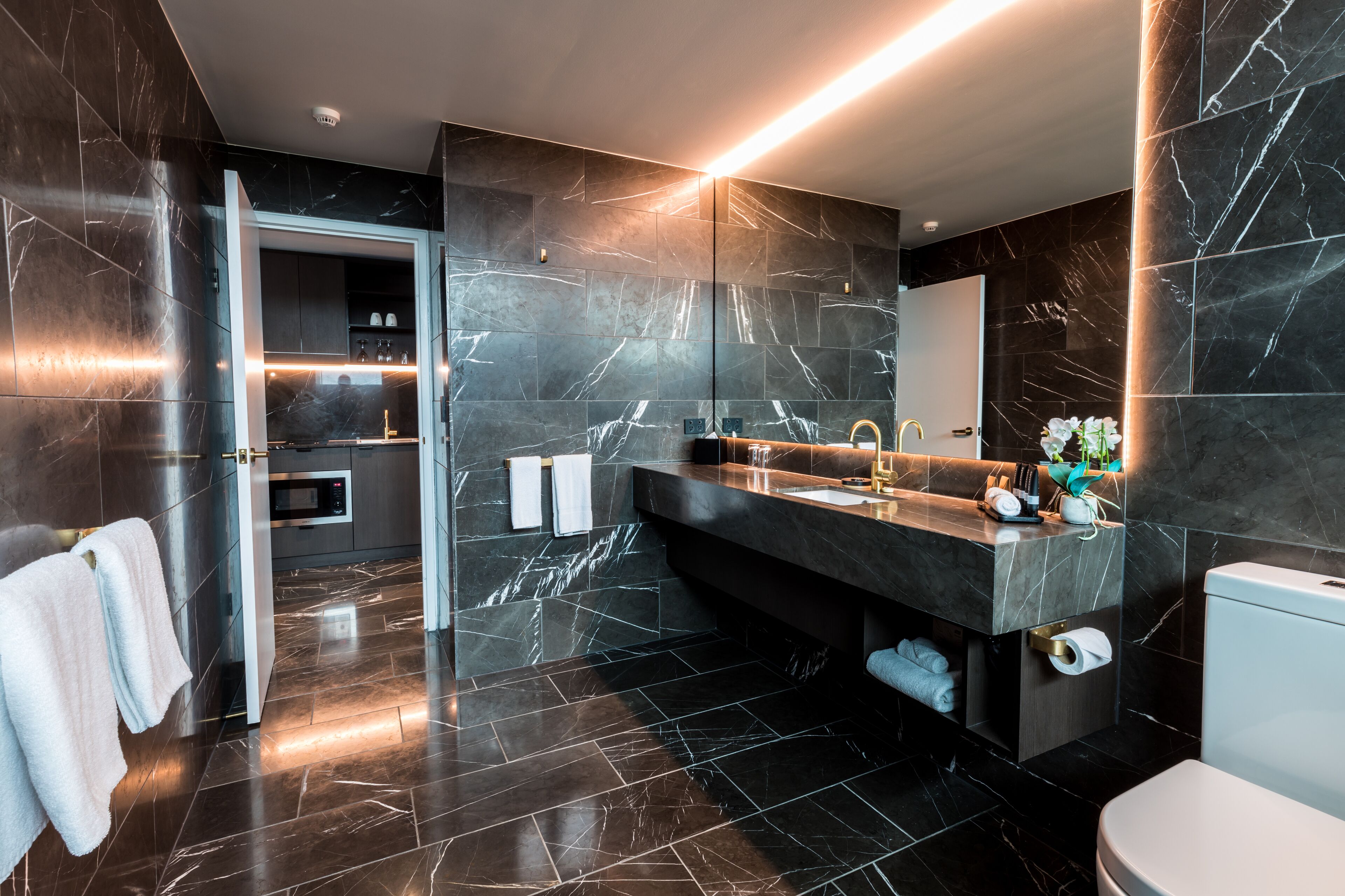 corner suite | bathroom | designer toiletries, hair dryer, towels