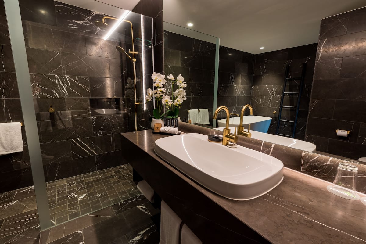 sky penthouse | bathroom | designer toiletries, hair dryer, towels