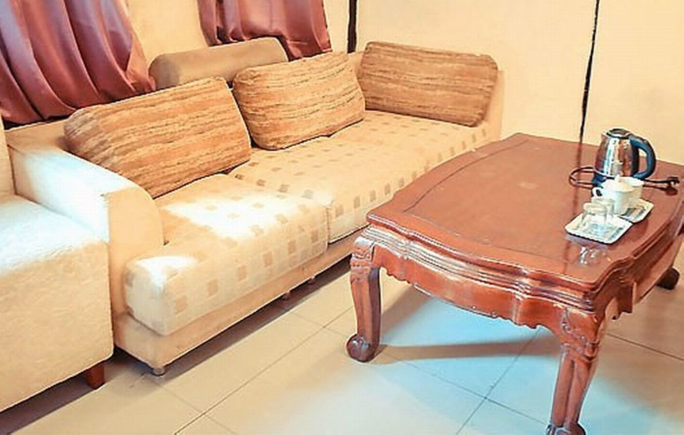 A living room with a sofa and a wooden coffee table.