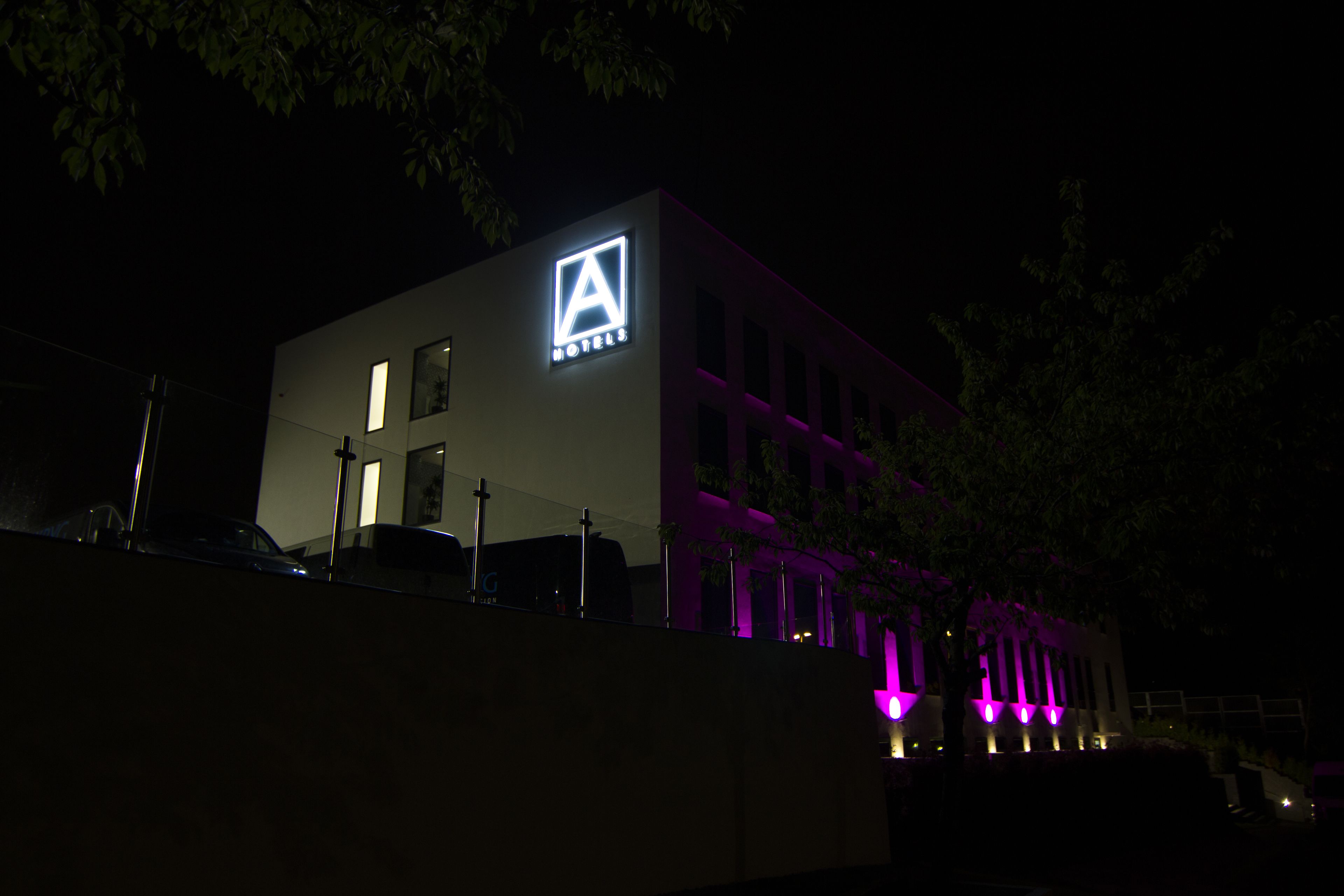 A modern building with a prominent 'A' logo and 'HOTELS' signage, indicating a hotel property.