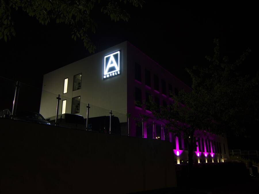A modern building with a prominent 'A' logo and 'HOTELS' signage, indicating a hotel property.