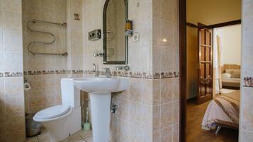 Un baño con inodoro, lavamanos y ducha.