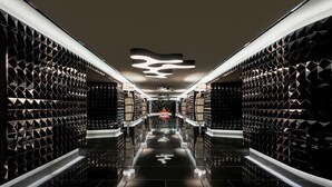 A modern, sleek hallway with geometric wall patterns and a reflective floor, leading to a central area with a unique ceiling design. - ibis Styles Ambassador Seoul Yongsan - Seoul Dragon City (Seoul)