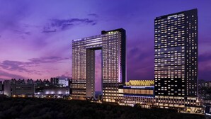 Two high-rise buildings with illuminated signage, one labeled 'Novotel Suites' and the other 'Grand Mercure.' - Grand Mercure Ambassador Hotel and Residences Seoul Yongsan (Seoul)