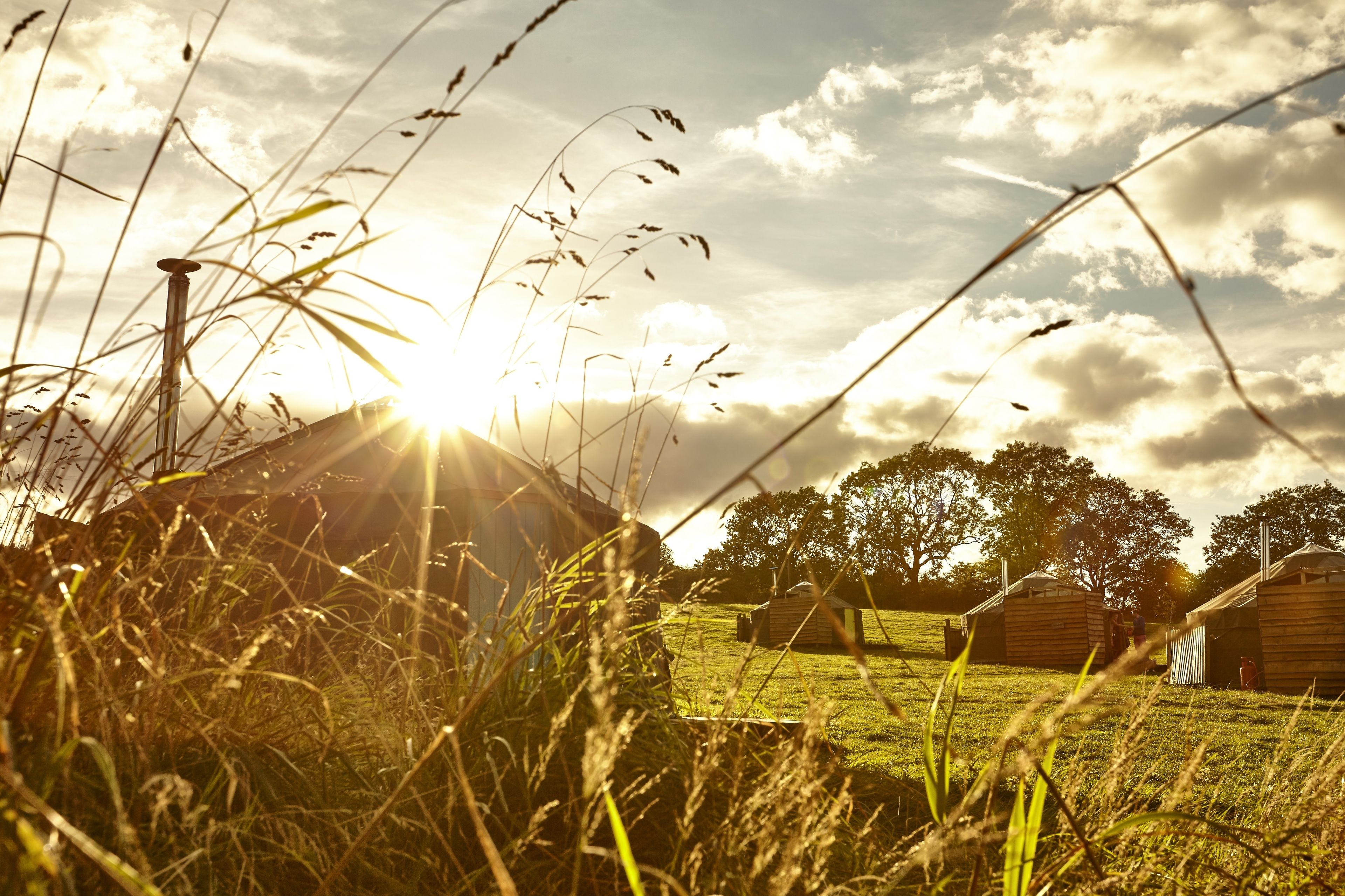 A rural setting with a barn and open fields.