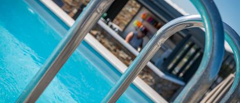 A pool with a metal ladder.