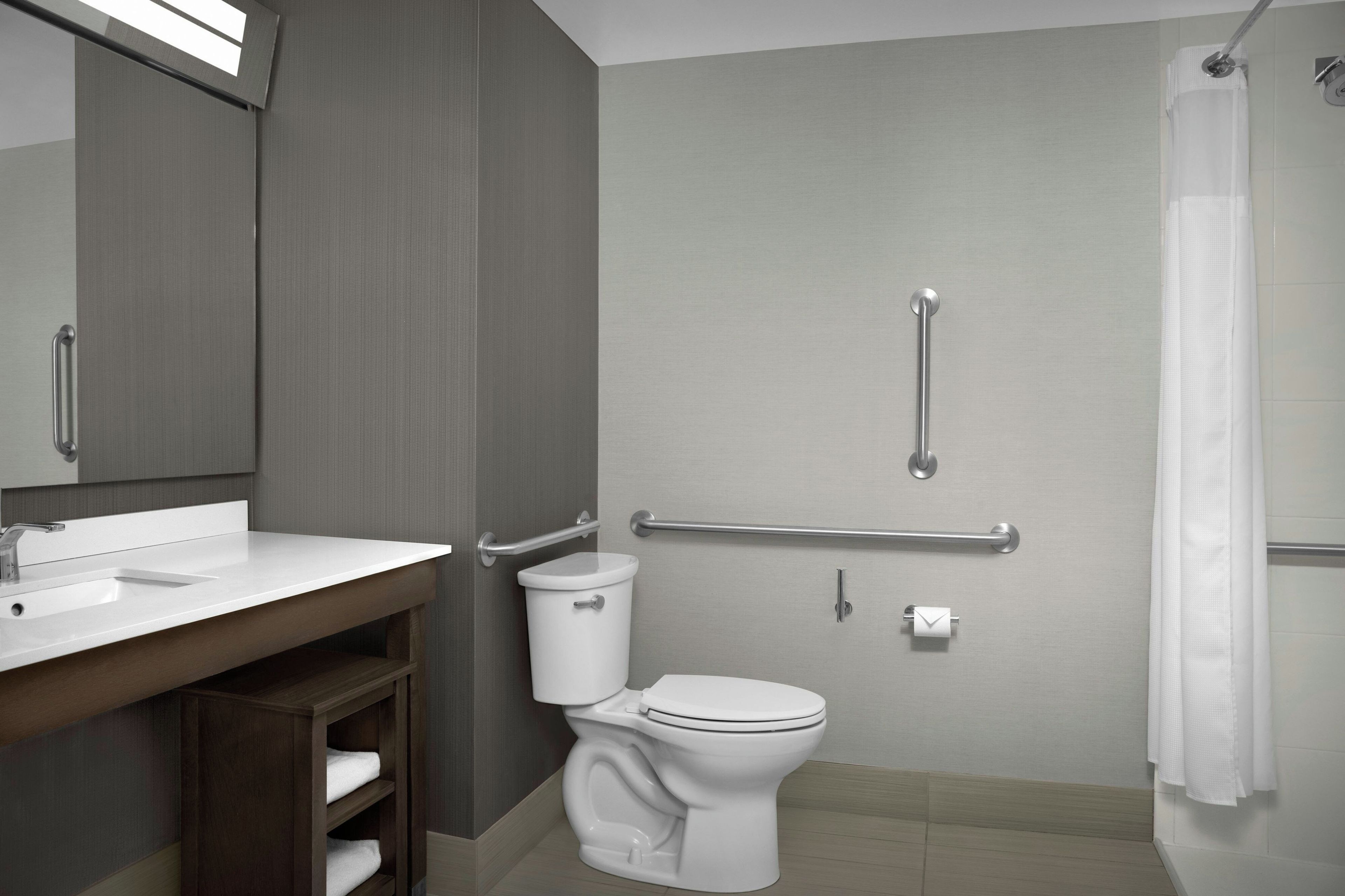 A modern bathroom with a toilet, bidet, and shower.