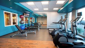 A gym with exercise equipment, a bench, dumbbells, and a treadmill. - Fairfield Inn & Suites by Marriott Detroit Lakes (Detroit Lakes)