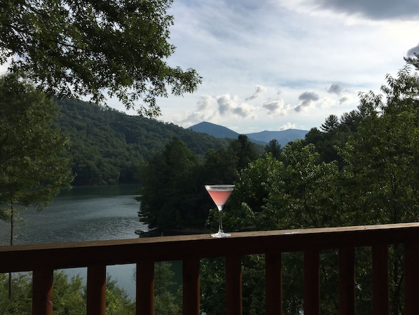 Un balcon avec vue sur un lac et des montagnes.