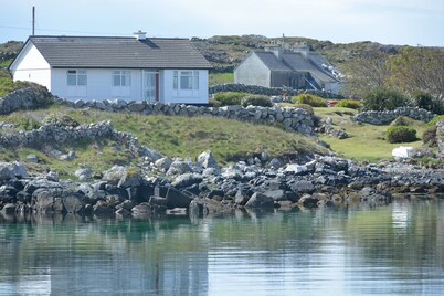 Right on the sea front bright bungalow with big secluded garden