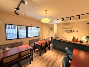 A restaurant interior with a bar area, seating arrangements, and a visible menu. - Reimeien (Osaka)