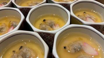 Multiple bowls of soup with visible ingredients like mushrooms and radish.