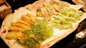A plate of tempura with various vegetables and seafood.