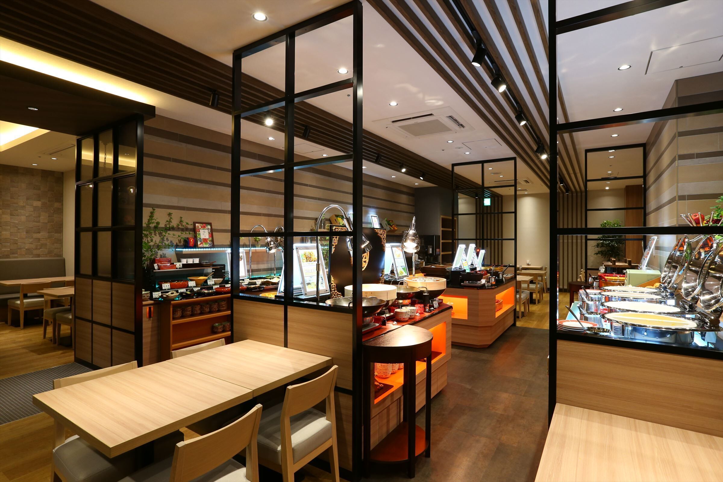 A restaurant interior with wooden furniture, a buffet area, and a seating section.
