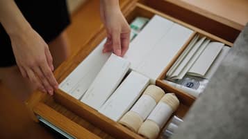 A wooden tray with neatly arranged toiletries including a toothbrush, toothpaste, and a razor.