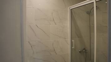 Shower, hair dryer, towels, toilet paper