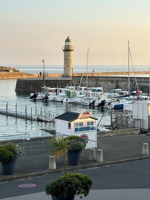 A harbor with boats docked, a lighthouse, and a small building labeled "Jetlocation".