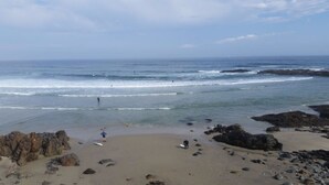 A beach with rocky outcrops and waves. - Beach Dreams Coastal Retreat, Pool, Hot Tub, Gym, Pickleball & Minutes to Beach (Wells)