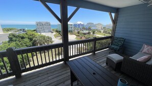 A wooden deck with a view of the ocean and buildings. - LAST MIN DISCOUNT LABOR DAY! 2nd ROW EASY beach access 1/2 block Ocean View (Emerald Isle)