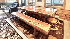 A spacious living area with a wooden bar, a sofa, and a coffee table. - Rhodehouse Retreat! Your destination for Year Round Fun! (Island Park)