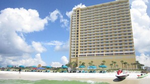A high-rise hotel with multiple balconies, a beachside location, and a view of the ocean. - HUGE Seasonal Discounts & Promotions, Beachfront HUGE End Unit, FREE BeachCHAIRS (Panama City Beach)