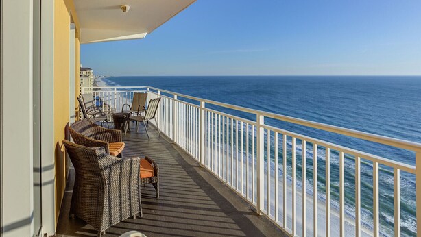 A balcony with wicker furniture and a view of the ocean. - HUGE Seasonal Discounts & Promotions, Beachfront HUGE End Unit, FREE BeachCHAIRS (Panama City Beach)