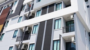 A multi-story building with a modern architectural design, featuring balconies, large windows, and air conditioning units. - At Yaya (Bangkok)