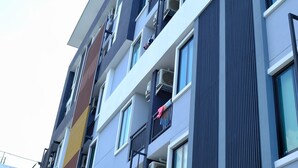 A multi-story building with balconies, large windows, and a modern architectural design. - At Yaya (Bangkok)