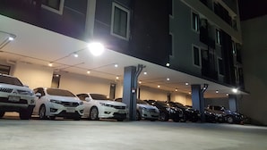 A parking garage with multiple cars parked under a covered area. - At Yaya (Bangkok)