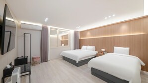 A hotel room with two beds, a desk, a mirror, a TV, and a window with curtains. - VIP Hotel Mokpo (Mokpo)
