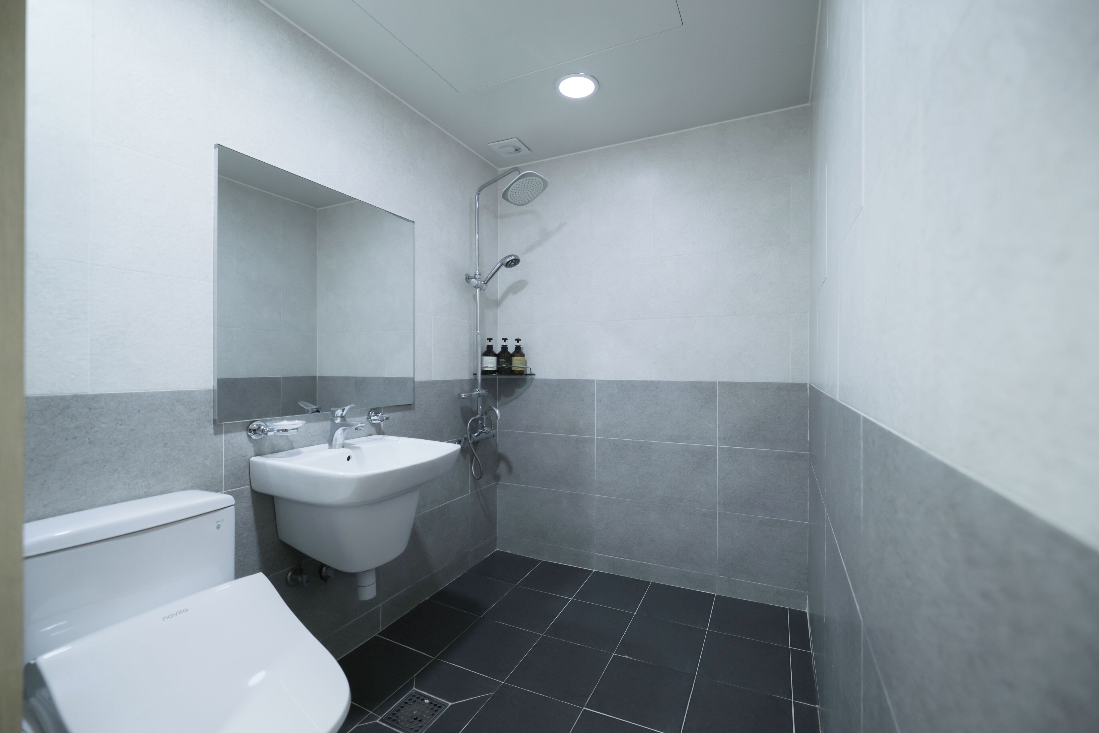 A modern bathroom with a toilet, bidet, and shower.