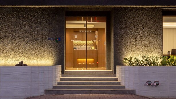 The exterior of the VIP Hotel Mokpo, featuring a modern entrance with glass doors and a sign above. - VIP Hotel Mokpo (Mokpo)