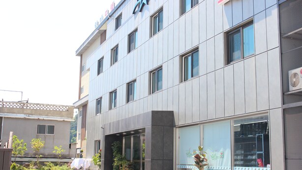 A modern building with multiple windows and a sign above the entrance. - The Lucete Hotel (Seogwipo)